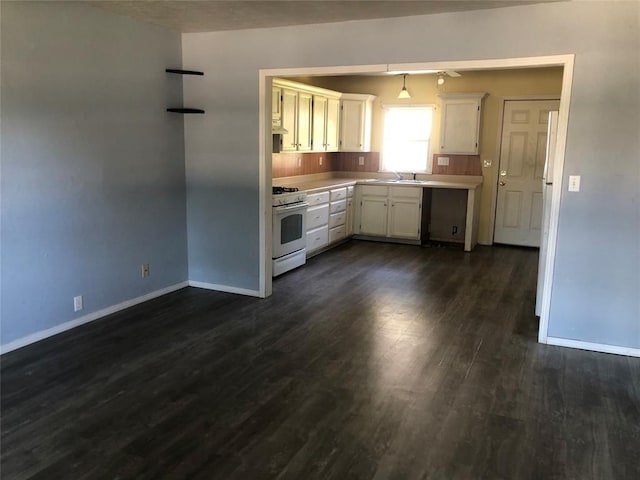 kitchen with pendant lighting, dark wood-type flooring, white cabinets, sink, and white gas range oven