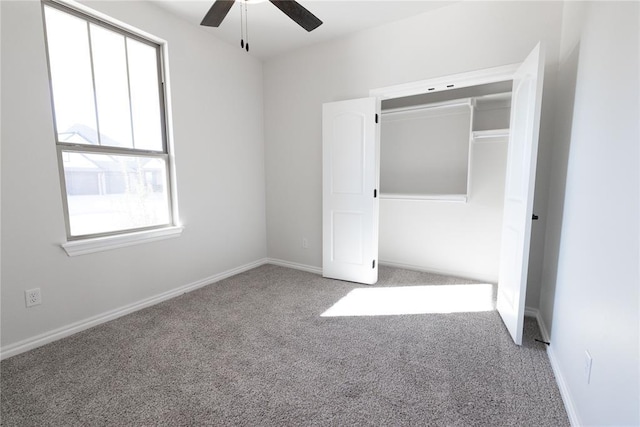 unfurnished bedroom with carpet floors, multiple windows, and baseboards