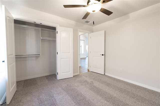 unfurnished bedroom with carpet floors, a closet, visible vents, a ceiling fan, and baseboards