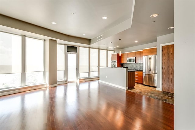 unfurnished living room with dark hardwood / wood-style flooring