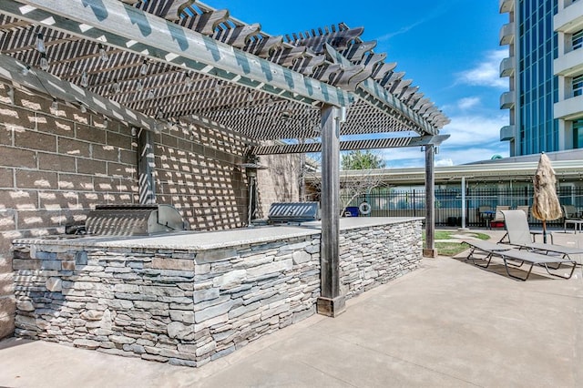 view of patio with exterior bar, area for grilling, and a pergola