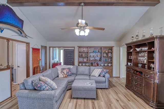 living room with a ceiling fan, light wood-style flooring, and lofted ceiling with beams