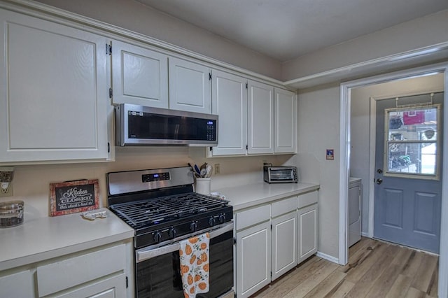 kitchen with light countertops, appliances with stainless steel finishes, and white cabinets