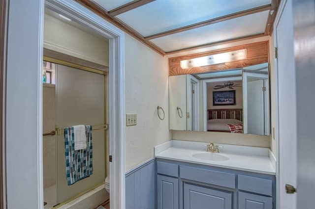 bathroom with toilet, a wainscoted wall, ensuite bath, and vanity