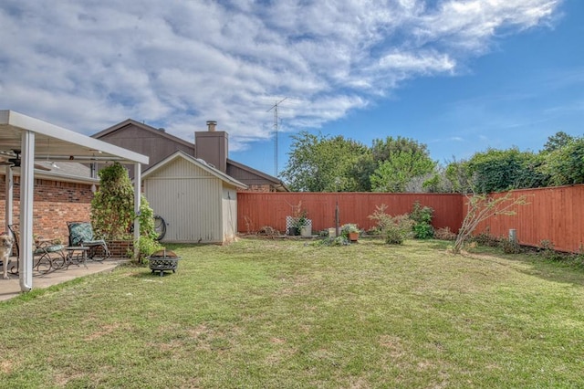 view of yard featuring an outdoor fire pit, a patio area, a shed, a fenced backyard, and an outdoor structure