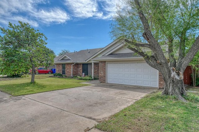 ranch-style house featuring a garage and a front lawn