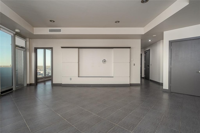 unfurnished living room with dark tile patterned flooring