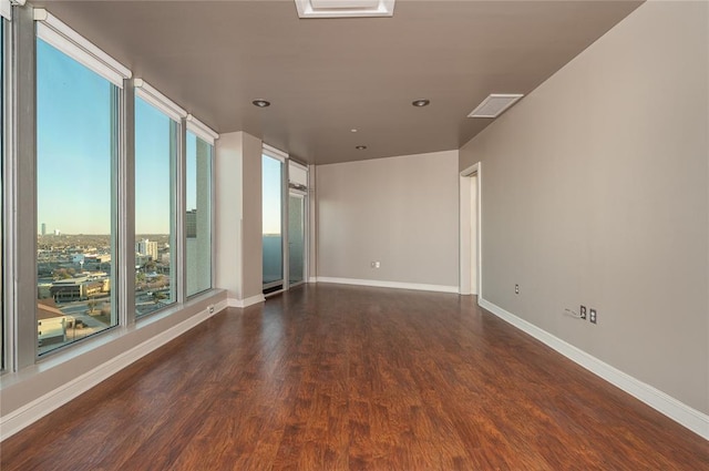 unfurnished room with dark wood-type flooring