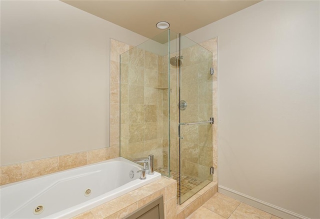 bathroom with tile patterned floors and shower with separate bathtub