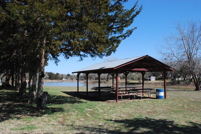 view of community featuring a gazebo, a water view, and a lawn