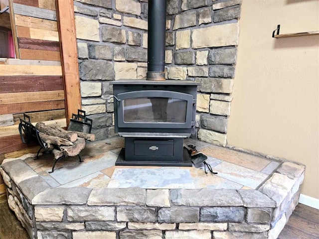 details featuring hardwood / wood-style floors and a wood stove