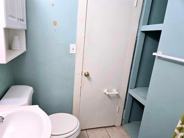 bathroom with tile patterned floors, sink, and toilet