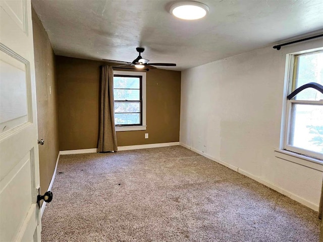 unfurnished room with ceiling fan and carpet floors