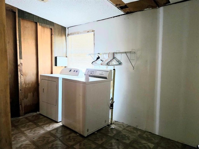 laundry room featuring a textured ceiling and separate washer and dryer