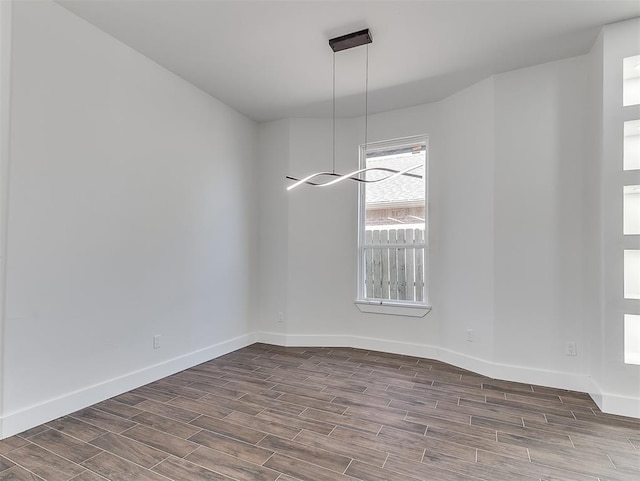 unfurnished dining area featuring dark wood-type flooring