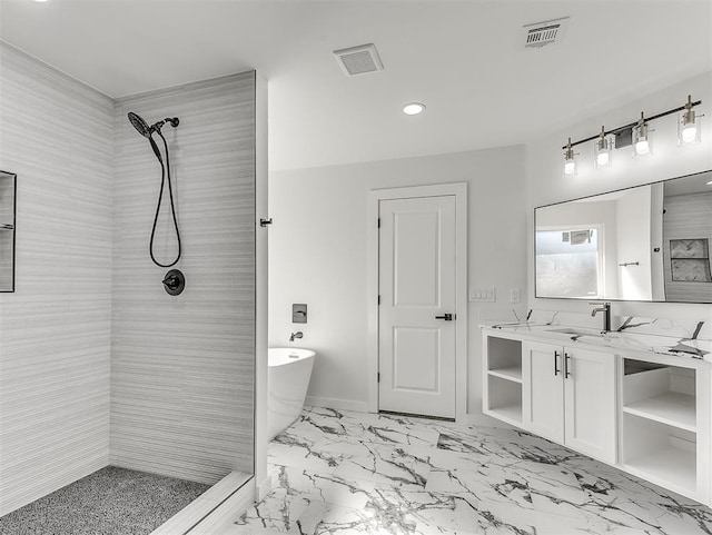 bathroom with vanity and shower with separate bathtub