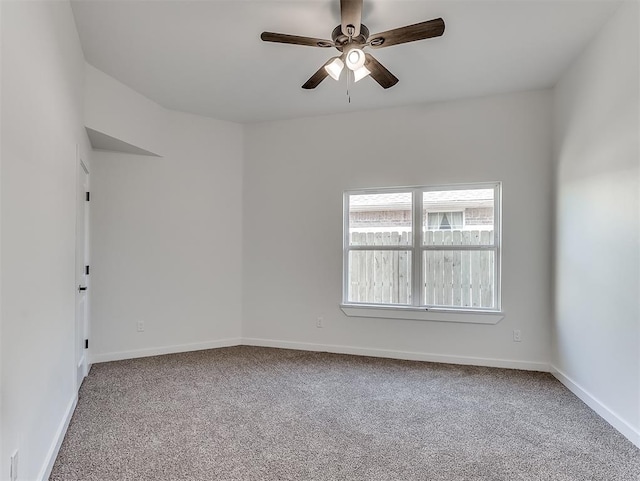 unfurnished room featuring ceiling fan and carpet