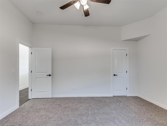 carpeted empty room featuring ceiling fan