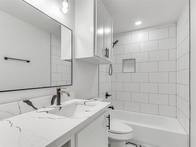 full bathroom featuring vanity, toilet, and tiled shower / bath