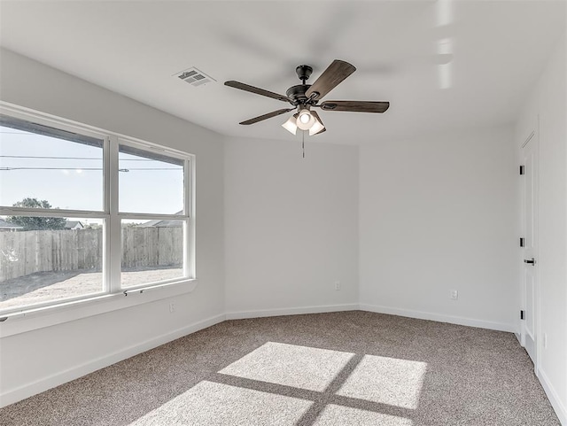 unfurnished room with ceiling fan and light carpet