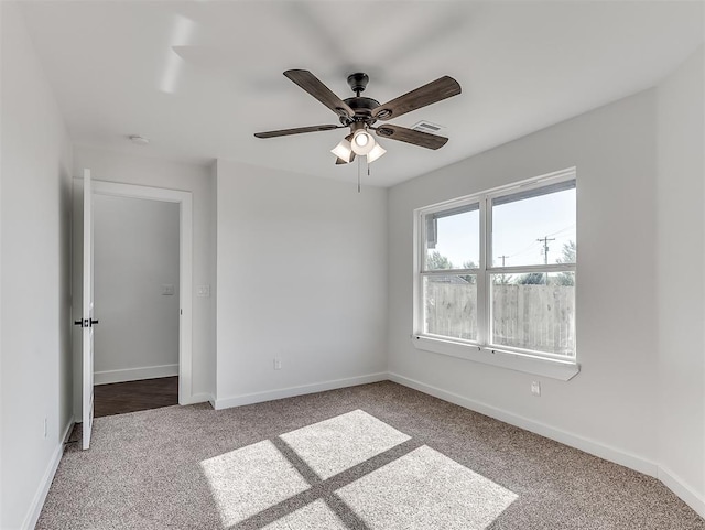 spare room with carpet floors and ceiling fan