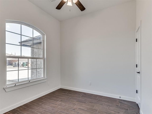 spare room with ceiling fan and dark wood-type flooring