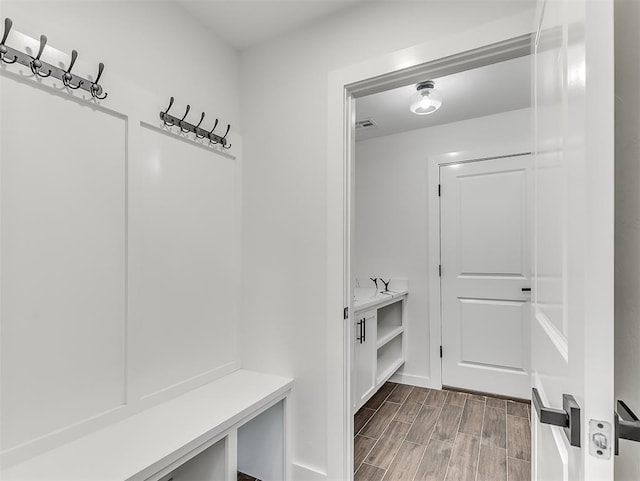 mudroom with wood-type flooring