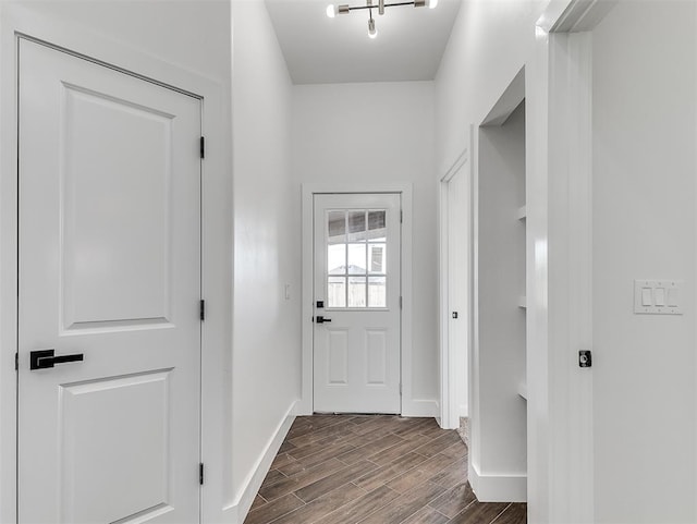 entryway featuring dark hardwood / wood-style flooring and a notable chandelier