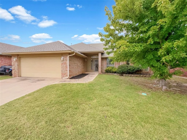 view of front of house with a front yard and a garage