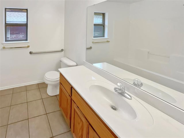 bathroom featuring toilet, vanity, tile patterned floors, and a wealth of natural light