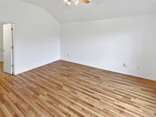 unfurnished room with ceiling fan, vaulted ceiling, and light hardwood / wood-style flooring