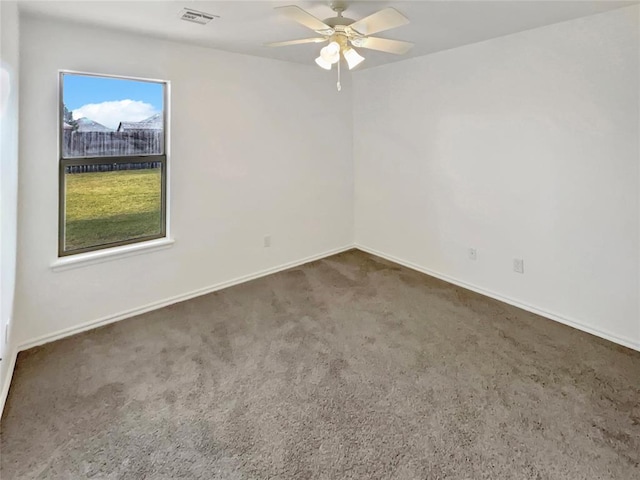 carpeted spare room with ceiling fan