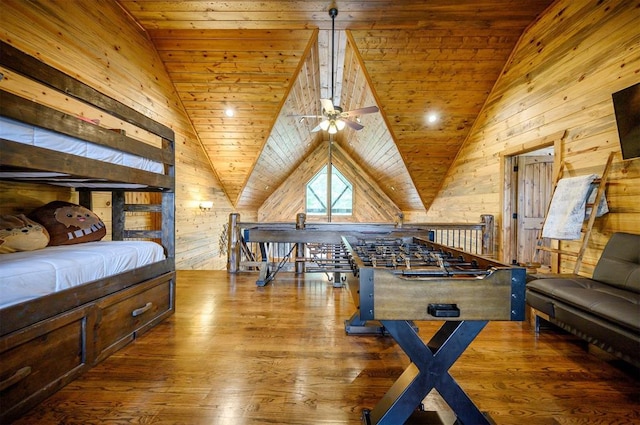 playroom with wood ceiling, vaulted ceiling, ceiling fan, wooden walls, and wood-type flooring