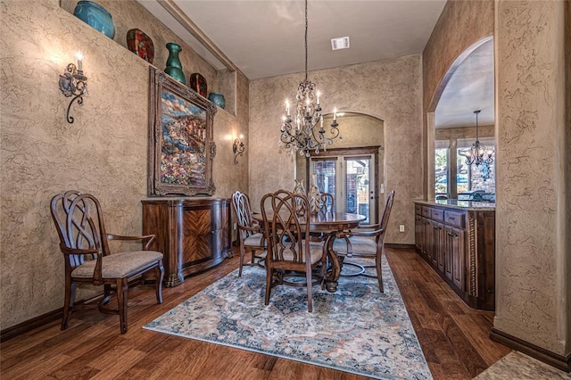 dining space featuring a notable chandelier and dark wood-type flooring