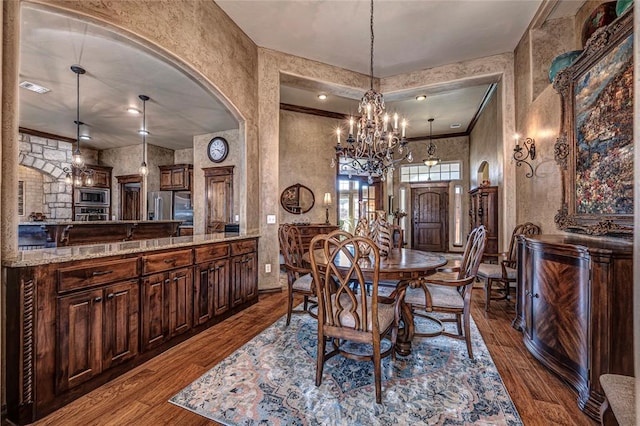 dining room with wood-type flooring and a chandelier