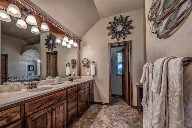 bathroom featuring vanity and lofted ceiling