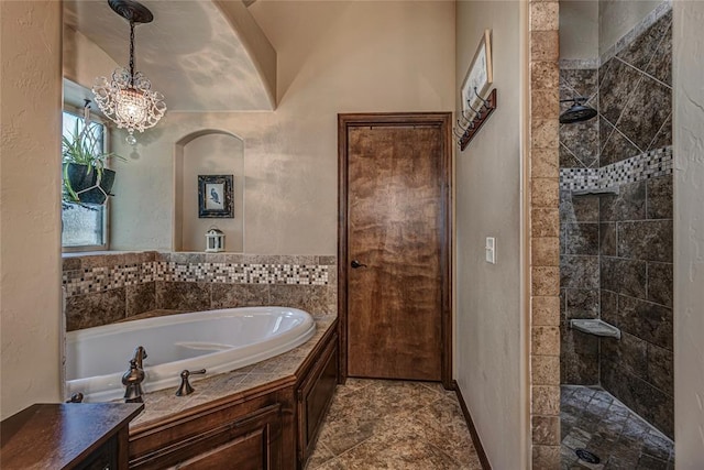 bathroom featuring separate shower and tub and an inviting chandelier