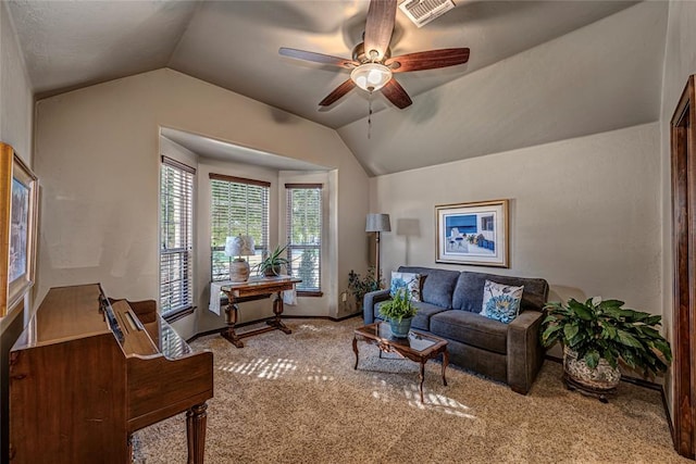 living room featuring ceiling fan, carpet, and vaulted ceiling