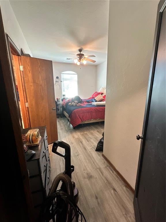 bedroom with ceiling fan and light hardwood / wood-style flooring