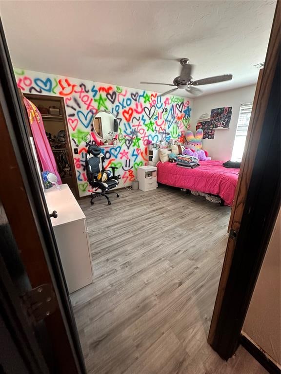 bedroom with ceiling fan and light hardwood / wood-style floors