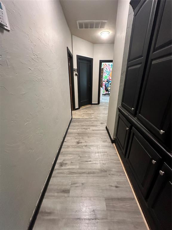 16355 Cobblestone Cir, Choctaw, OK 73020 - hallway featuring light wood-style flooring and baseboards