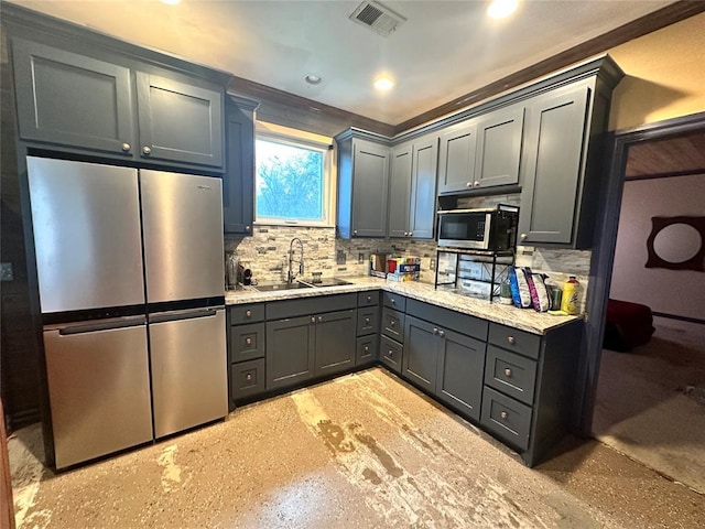 kitchen with stainless steel appliances, tasteful backsplash, gray cabinetry, and sink