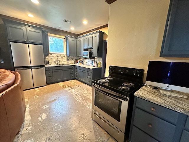 kitchen featuring light stone countertops, sink, backsplash, gray cabinets, and appliances with stainless steel finishes