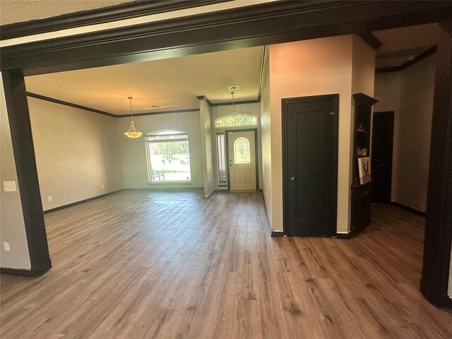 16355 Cobblestone Cir, Choctaw, OK 73020 - unfurnished living room with ornamental molding and wood finished floors