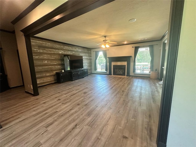 16355 Cobblestone Cir, Choctaw, OK 73020 - unfurnished living room featuring ceiling fan, a fireplace, wood finished floors, and crown molding