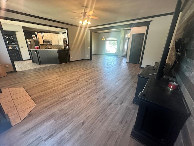 16355 Cobblestone Cir, Choctaw, OK 73020 - living room featuring a ceiling fan, light wood-style flooring, and ornamental molding