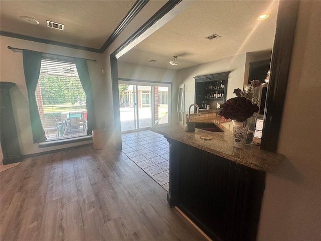 16355 Cobblestone Cir, Choctaw, OK 73020 - living room with bar with sink, wood finished floors, and a textured ceiling