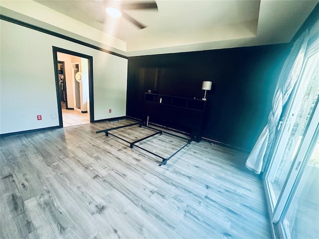 16355 Cobblestone Cir, Choctaw, OK 73020 - bedroom featuring wood finished floors, a ceiling fan, and a raised ceiling