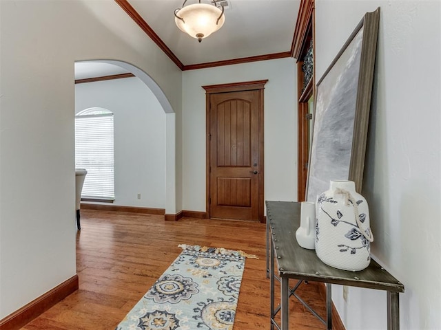 foyer entrance with hardwood / wood-style floors and ornamental molding