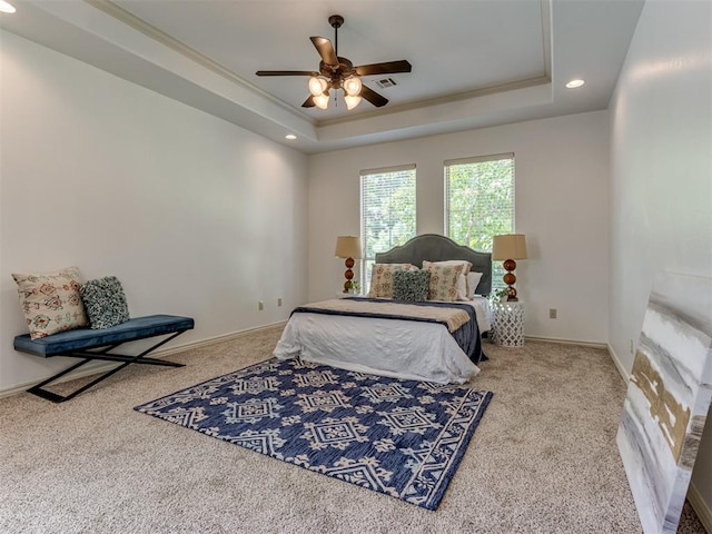 bedroom with carpet, a raised ceiling, ceiling fan, and ornamental molding